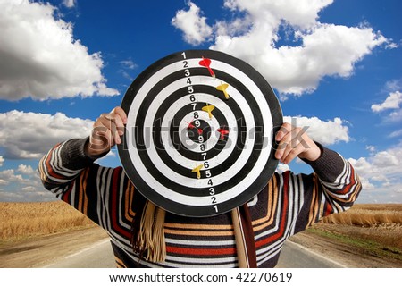 Boy with target at road background