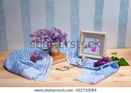 still life with lilacs, a picture frame and a silk scarf