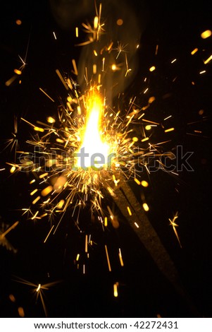 sparking Bengal fires on black background close-up