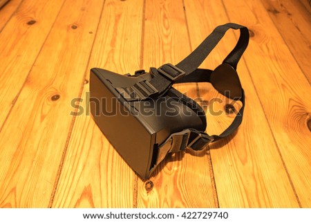 VR Glasses on top of wooden background. close up