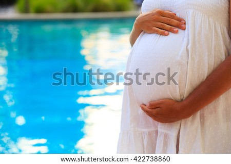 happy pregnant woman on beach