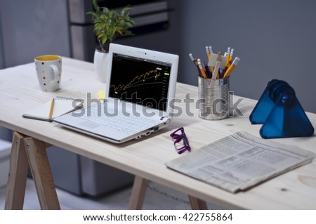 Industrial workspace with computer for analysis,glasses,pencils and newspapers. / Minimal office on white background. 