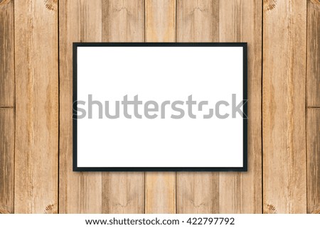 Mock up blank poster picture frame on wood wall.