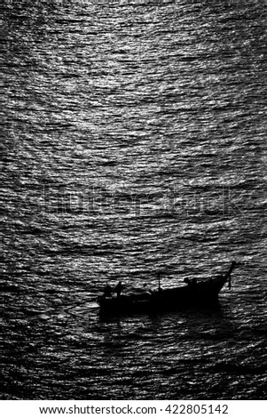 Lonely fishing boat on the sea. In the end of day the fisherman come back home to meet his wife  and son.