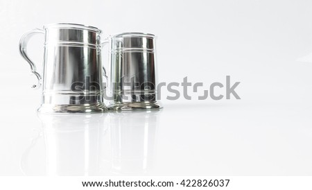 Silver goblet or pewter mug. Isolated on empty background. Slightly de-focused and close-up shot. Copy space.
