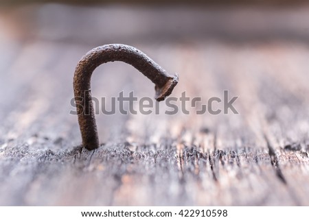 old rusty nail in the piece of wood