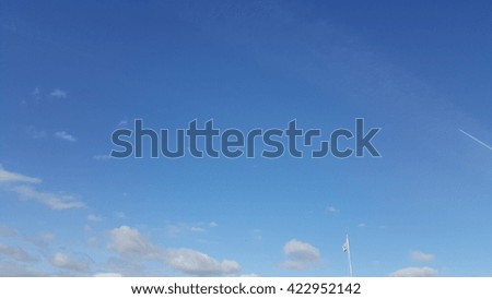 cloud on blue sky. (flag,air craft)