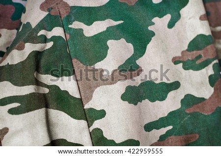 Camouflage fabric texture background. Soft selective focus and shallow depth of field