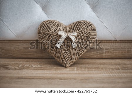 Wedding dress on a wooden hanger. Piano.
