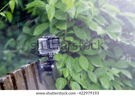 Action camera in a protective cover in the rain