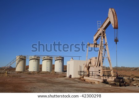 Oil well with Storage Tanks in the tackground
