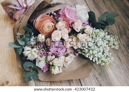Beautiful flower bouquet on the wooden table background Royalty-Free Stock Photo #423007432