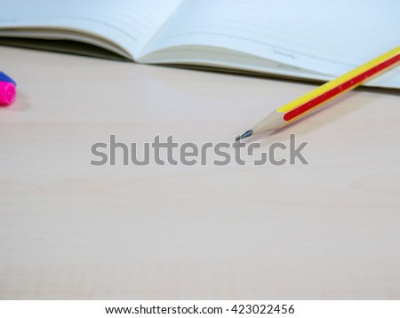 pencil  with notebook on desk