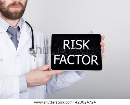 technology, internet and networking in medicine concept - Doctor holding a tablet pc with risk factor sign. Internet technologies in medicine
