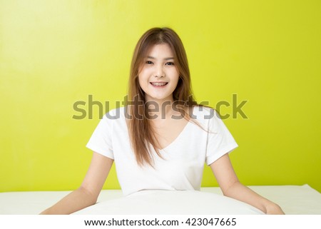 Young woman showing open hand palm with copy space for product or text.female model isolated on green background.