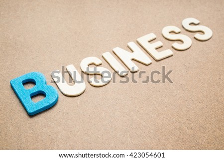 Text 'Business' wording on brown background - Business colorful uppercase letters made from wood