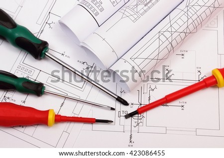 Rolls of diagrams and screwdrivers on electrical construction drawing of house, work tool and drawing for projects engineer jobs, concept of building house