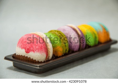  assortment of colorful macaroon cookies on a paper cup