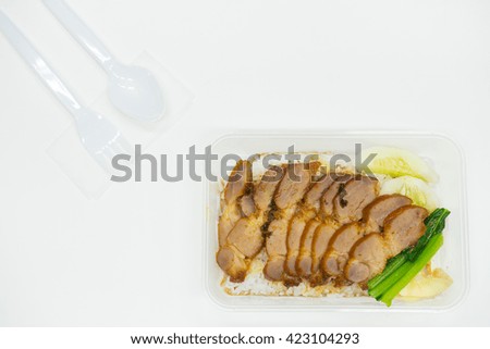 Barbecued red pork in sauce with rice in packed lunch