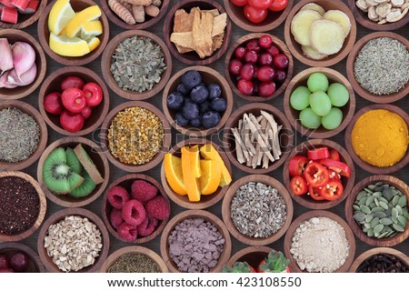 Health and super food  to boost immune system in wooden bowls, high in antioxidants, anthocyanins, minerals and vitamins. Also good for cold and flu remedy. Royalty-Free Stock Photo #423108550