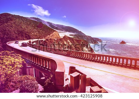 Bixby Creek Bridge on Highway #1 at the US West Coast traveling south to Los Angeles, Big Sur Area - Picture in a dreamy look with purple fall color look