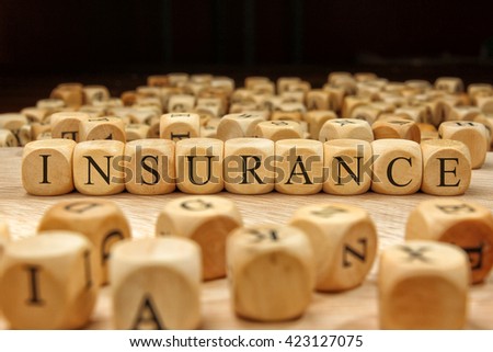 Insurance word written on wood block