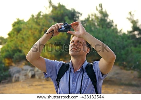 White men taking photo of birds in the sky