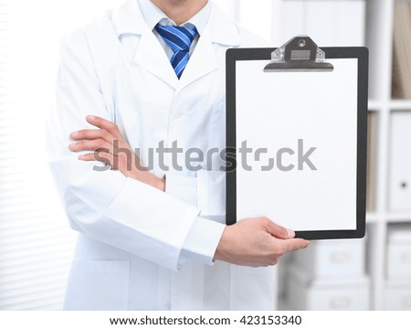 Medical sign - doctor showing clipboard with copy space for text or design. Horizontal shot.
