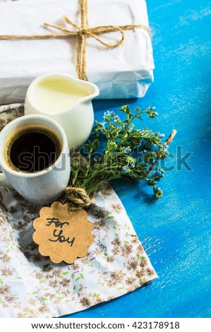 Forget-me-not spring flowers and cup of coffee  on wooden rustic background