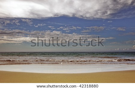 photo of a dramatic beach with clouds