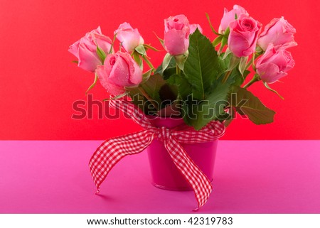 Cheerful bouquet pink roses with checkered ribbon