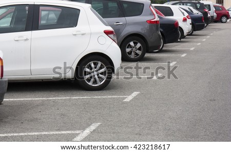 Cars in the parking lot in row Royalty-Free Stock Photo #423218617