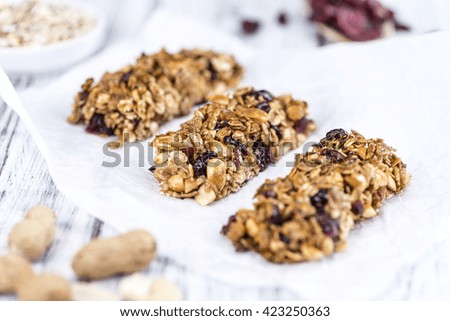 Homemade Granola Bars with Peanuts and Cranberries (selective focus) as detailed close-up shot