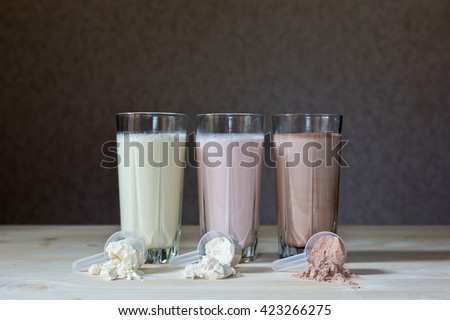 Fresh milk, chocolate, blueberry and banana drinks on table, assorted protein cocktails. Royalty-Free Stock Photo #423266275