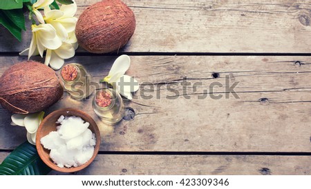 Coconuts and coconut oil on  vintage wooden background. Selective focus. Flat lay. Natural organic spa products. Place for text.  Toned image.