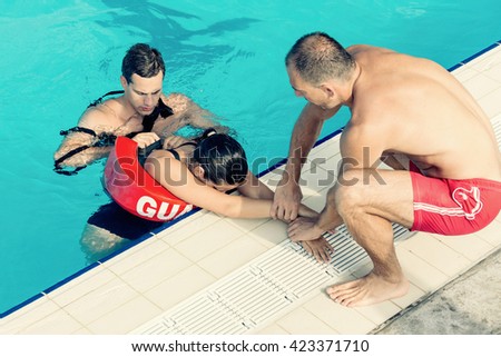 Lifeguards in training - Rescuing female victim from public swimming pool