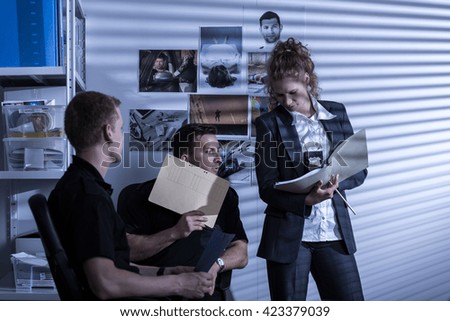 Shot of three police officers trying to solve a case