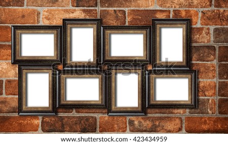 Eight picture photo frames on the red brick wall