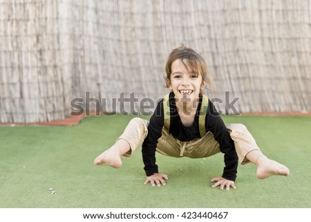 One girl playing on a floor with Astroturf