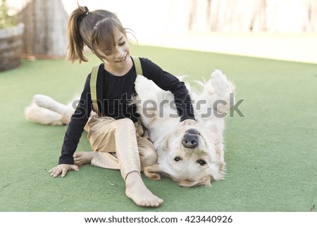 Little girl with her dog with signs of affection