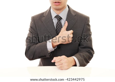 Business man showing thumbs up sign 