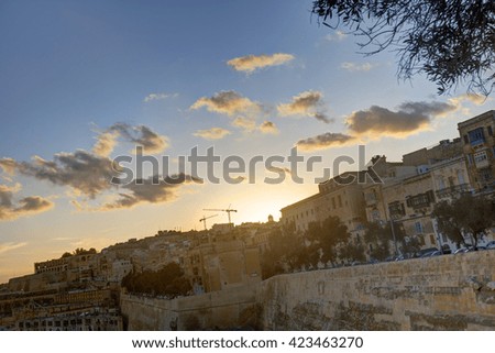 Dark HDR colorful vivid sunset photo over historic Valletta city cityscape