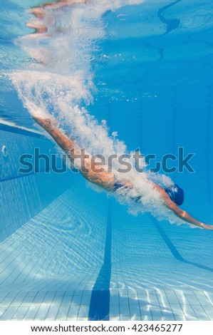 Young woman jumps into the swimming pool