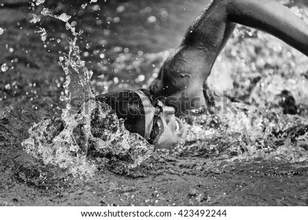 Swimming fast - high speed action shot in black and white