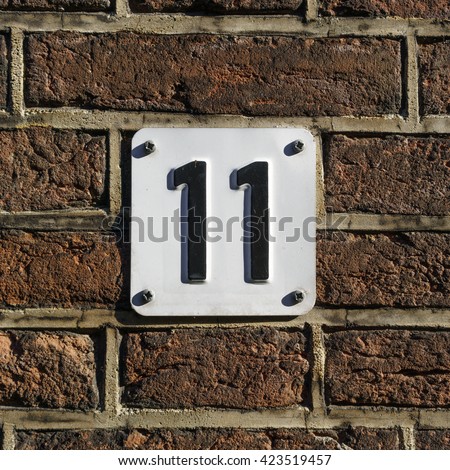 House number eleven, embossed in a metal plate