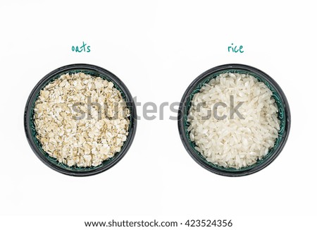 White rice and oatmeal in bowls, on white background