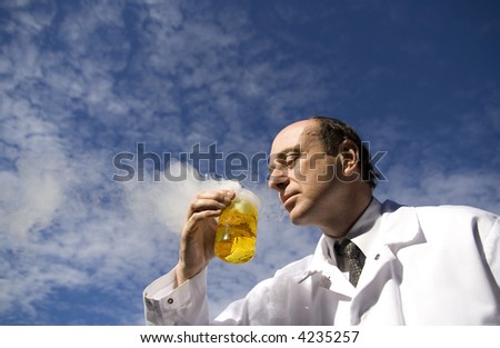Image of a scientist with a colored beaker.