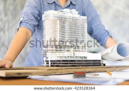architecture show her model Simulate on blueprint architectural concept, soft focus Royalty-Free Stock Photo #423528364