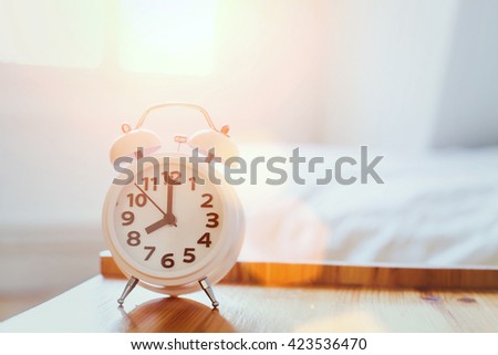 morning time background, alarm clock near the bed at home