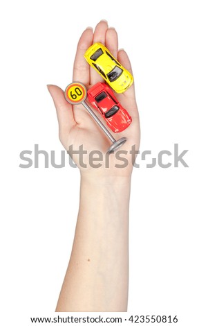road signs and cars in a hand isolated on white background. driving school concept